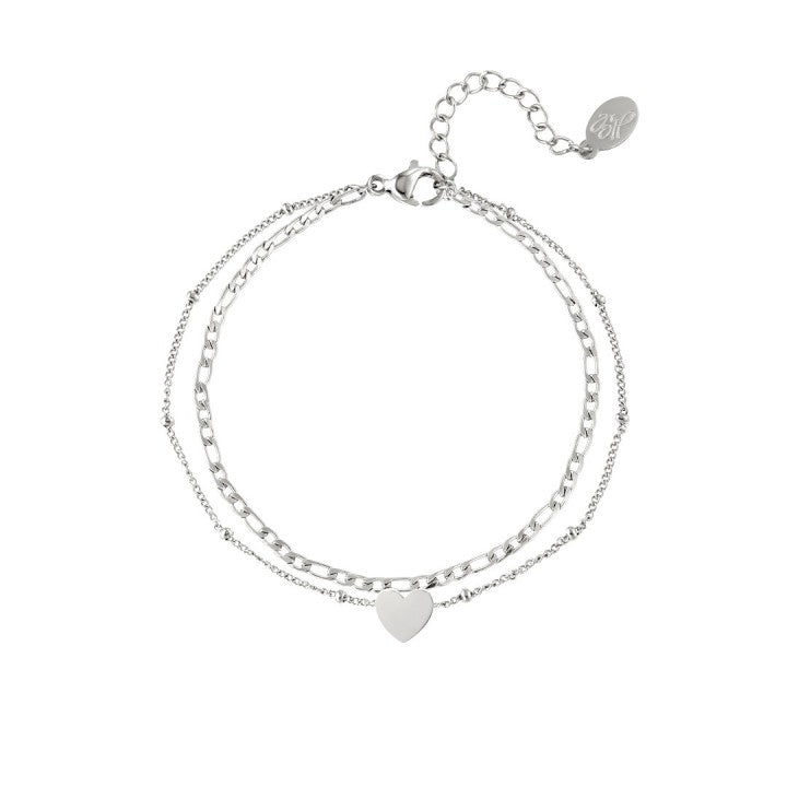 Roestvrijstalen meerlaagse armband met hartjeshanger  Kleur: Zilver Materiaal: Stainless Steel / Nickel Free Afmeting: ca. 16cm + 3cm Merk: Yehwang  Kleur foto kan iets afwijken van origineel